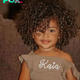 Embrace the irresistible charm of curly-haired babies