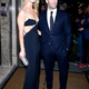 rr Rosie Huntington-Whiteley stuns in a daring black gown, exuding allure as she embraces fiancé Jason Statham at the Harper’s Bazaar Women Of The Year Awards.