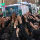 Thousands Attend Iranian President Raisi’s Funeral Procession, as Others Celebrate