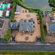 B83.Tyson Fury’s VAST Gypsy King Logo Dominates the Drive at His Palatial £1.7 Million Lancashire Mansion, Surrounded by Caravans, Mobile Homes, Static Homes, and a Sprawling Lake