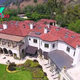 B83.Robbie Williams profited when he sold his massive Beverly Hills mansion with 10 bedrooms and 22 bathrooms to rapper Drake for ‘$50 million’ after seven years of buying it for $32 million.