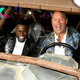 B83.Kevin Hart and Dwayne Johnson make a grand entrance in a custom car at a movie premiere.