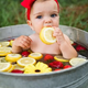 The cuteness of the children is captured through images of them bathing with delicious fruit.