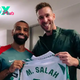 “I’m leaving!” – Mo Salah & Kostas Tsimikas given cheeky gifts on Liverpool reunion