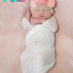 A newborn baby girl with platinum hair and radiant skin makes a special impression on the beholder.