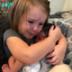 Emotional meeting: A baby girl’s heartfelt reaction as she meets her newborn sibling for the first time.