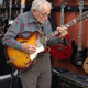 An 81-year-old grandpa walks into a guitar store, picks up one of the guitars, and starts playing to everyone’s amazement.