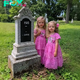 The girls visit their dad’s grave to “show” him their new dresses as he had wished, only to find two boxes with their names on them