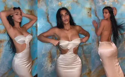 Sєxy Kim Kardashian flaunts her voluptuous figure in a strapless-backless satin gown