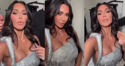 Kim Kardashian exudes glamour donning a a sparkling form-fitting dress at her family’s annual Christmas Eve bash while showing off new brunette locks