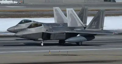 The F-22 Raptor has a longer range and a redesigned stealth fuel tank with configurable stealth.