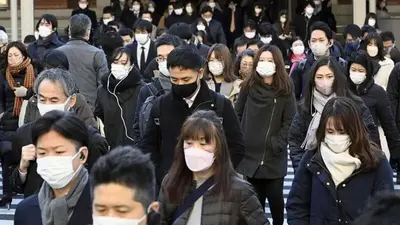 Japan to lower COVID-19 to flu status, further easing rules