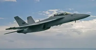 A US Navy F/A-18 Super Hornet Block III test fighter pilots three unmanned aerial vehicles (UAVs)