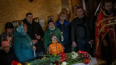 Relatives bury children killed in Russian missile attack