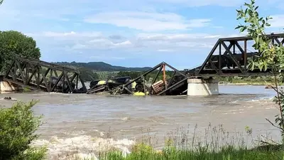 A bridge over Yellowstone River collapses, sending a freight train into the waters below