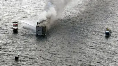 A fire is still burning on board a car-carrying cargo ship near a sensitive Dutch bird habitat