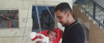 Syrian baby born under earthquake rubble turns 6 months, happily surrounded by her adopted family
