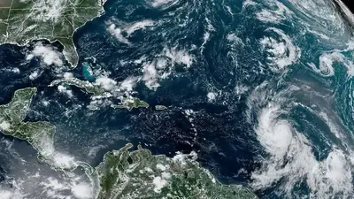 Tropical Storm Lee strengthens into a hurricane as it churns across Atlantic toward Caribbean