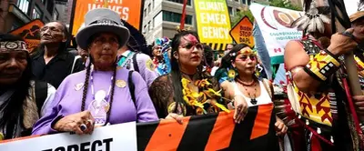 Thousands march to kick off climate summit, demanding an end to fossil fuels