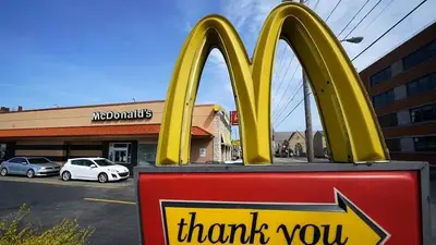 McDonald's promotions lure diners despite higher menu prices and revenue jumps 14%