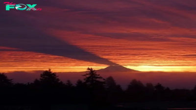 The rare moment when Mount Rainier casts a shadow on the clouds creating a scene like in the movies