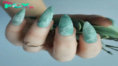 b83.Emerald green nail designs with delicate and elegant patterns for soft and gentle-looking hands.