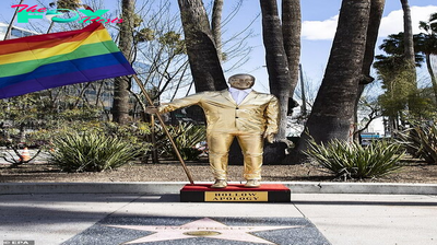 B83.Golden Statue of Kevin Hart with Rainbow Flag Emerges Near Oscars Venue Amid Controversy