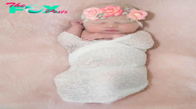 A newborn baby girl with platinum hair and radiant skin makes a special impression on the beholder.