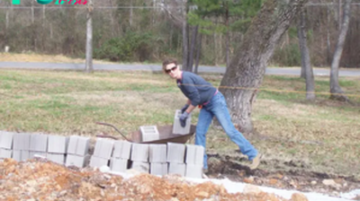 Her husband used to beat her frequently, so she took her children and ran away from home. She had nowhere to stay and not much money, so she decided to build a house with her own hands. Only her children helped her. All the neighbors laughed at her.