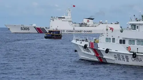 Philippine boats breach a Chinese coast guard blockade in a faceoff near a disputed shoal