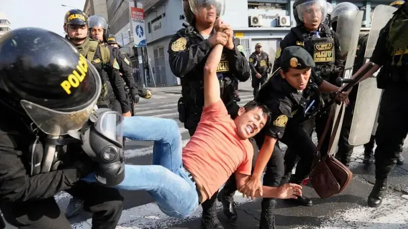 Protests move into Peru’s capital, met by tear gas and smoke