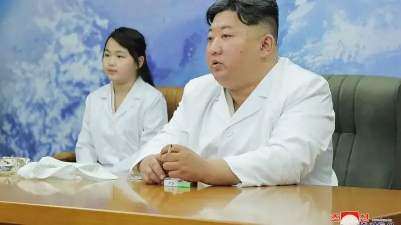 North Korea shows Kim Jong Un examining a military spy satellite that may be launched soon