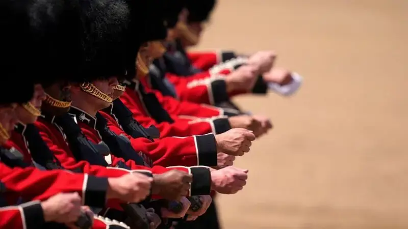 Troops feel the heat, and several faint, as Prince William reviews military parade