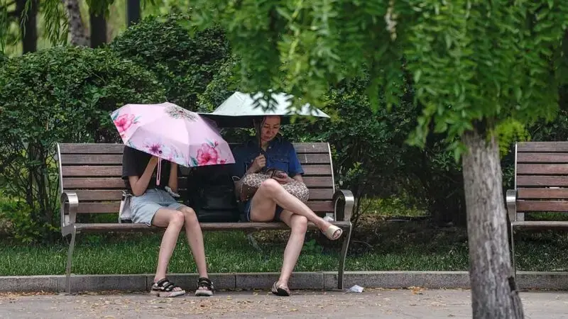 Flooding displaces 10,000 around China as Beijing gets a relative respite from sweltering heat