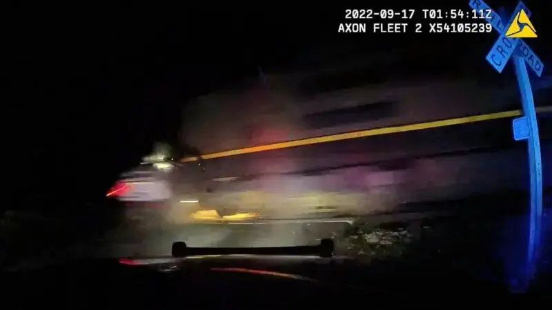 Officer who put woman in police car hit by train didn't know it was on the tracks, defense says