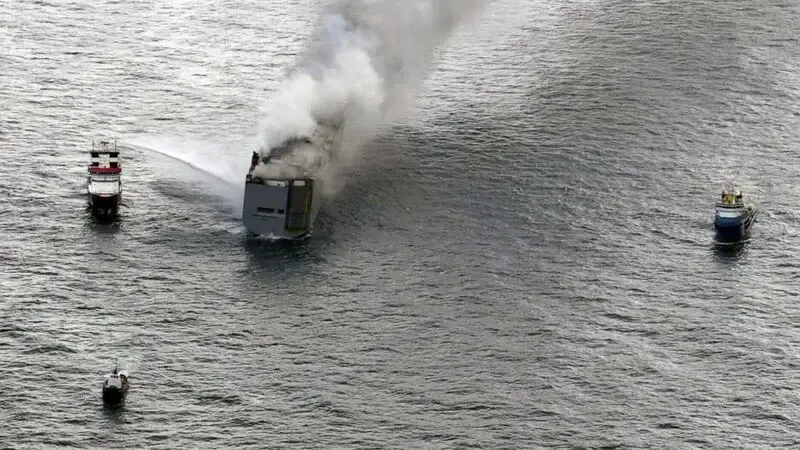 A fire is still burning on board a car-carrying cargo ship near a sensitive Dutch bird habitat