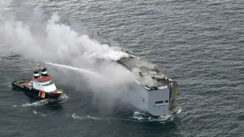 Salvage crews wait for chance to board a freighter burning for 2 days off the Dutch coast