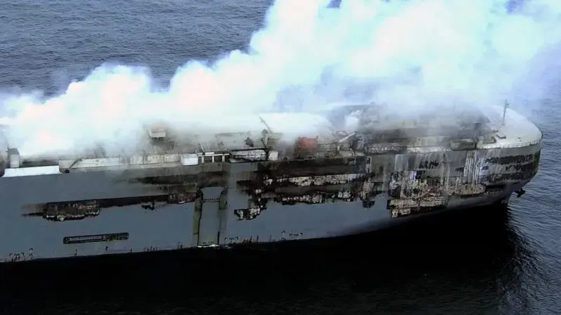 High winds stall efforts to tow a burning cargo ship packed with cars off northern Dutch coast