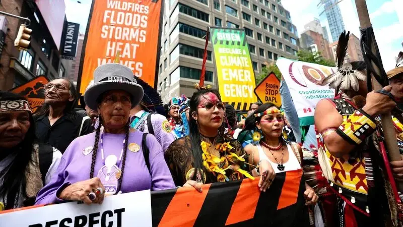 Tens of thousands march to kick off climate summit, demanding end to warming-causing fossil fuels