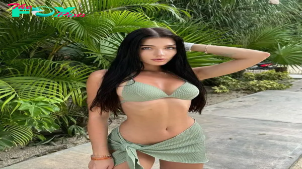 Alina poses sweetly in a green beach outfit