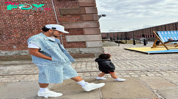 rr Liverpool star Luis Diaz embodies greatness as he enjoys a serene day, strolling alongside his wife and daughter, exemplifying the essence of fatherhood.