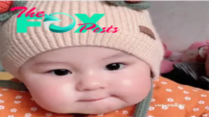 nht.Heartwarming Scene: Young girl with rosy cheeks enjoying cake ‎.