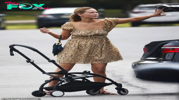 4t.Jennifer Lawrence dazzles in a chic patterned sundress, showcasing her hands-on mom skills while strolling with her family in New Jersey.