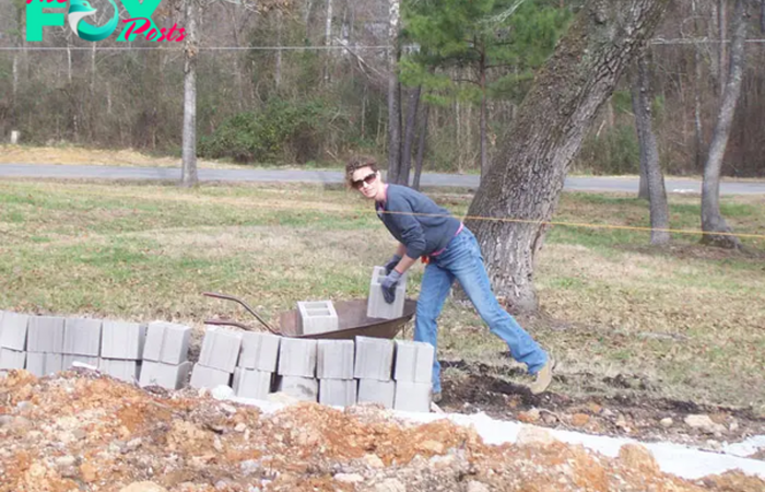 Her husband used to beat her frequently, so she took her children and ran away from home. She had nowhere to stay and not much money, so she decided to build a house with her own hands. Only her children helped her. All the neighbors laughed at her.