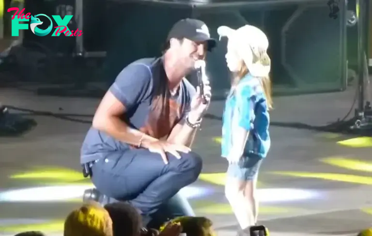 Luke Bryan accompanied by an enthusiastic young fan on stage who sings along to every word!